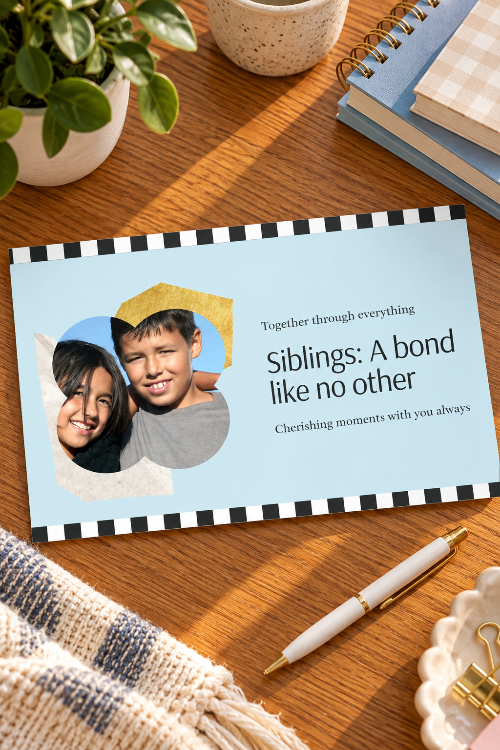 • A light blue sibling greeting card with black-and-white checkered borders featuring a wavy butterfly-shaped photo frame of a smiling brother and sister, next to clean black text reading 'Siblings: A bond like no other'.