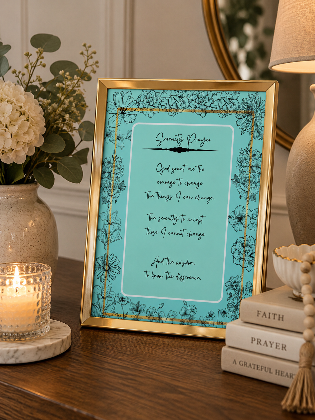 turquoise blue with a floral border serenity prayer christian art sitting upright on a decorative desk.