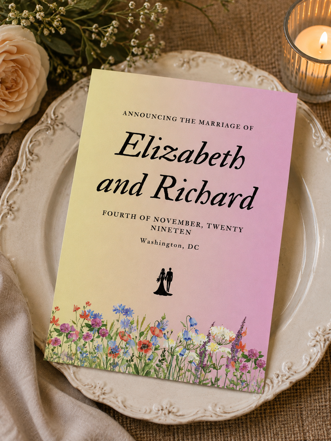 A wedding announcement card with a yellow to pink ombre gradient background and a colorful watercolor wildflower border.