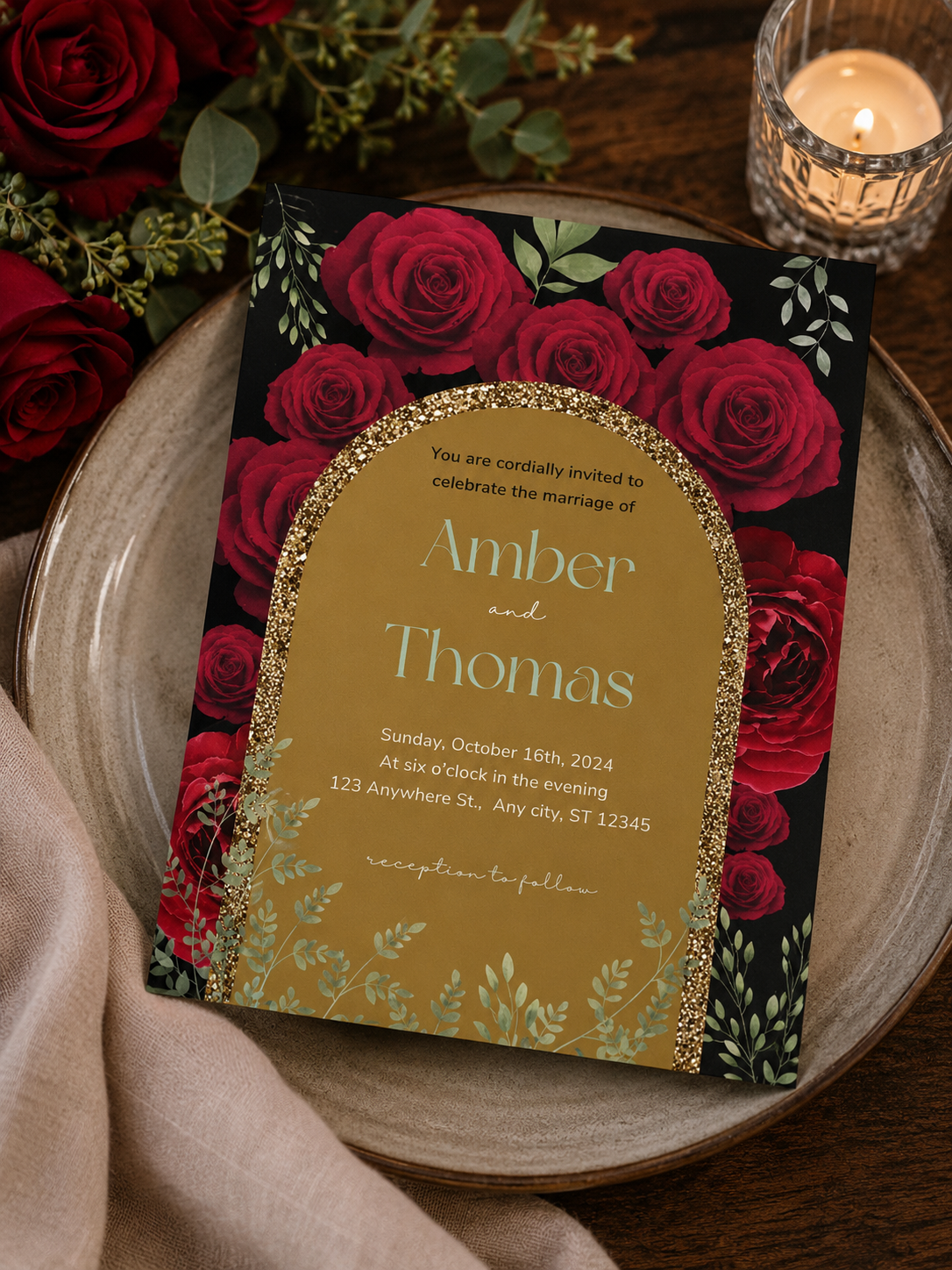 A dramatic black and dark gold wedding invitation featuring an archway cutout framed by deep red roses and botanical greenery.