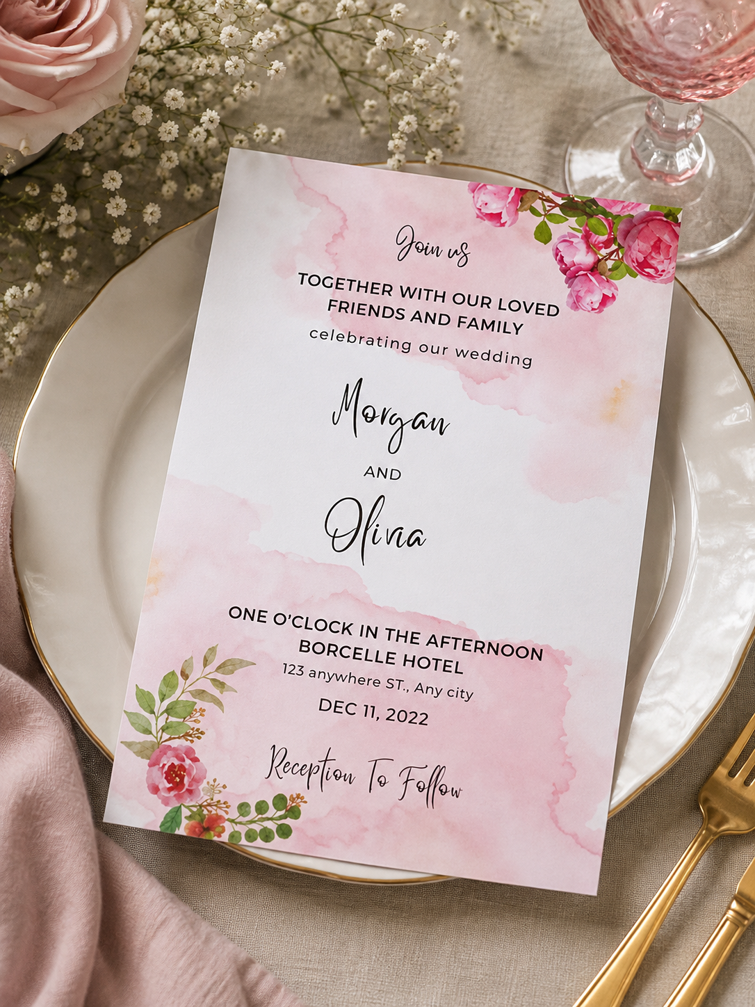 A white wedding invitation card featuring large blush pink watercolor splashes and vivid pink rose corners.