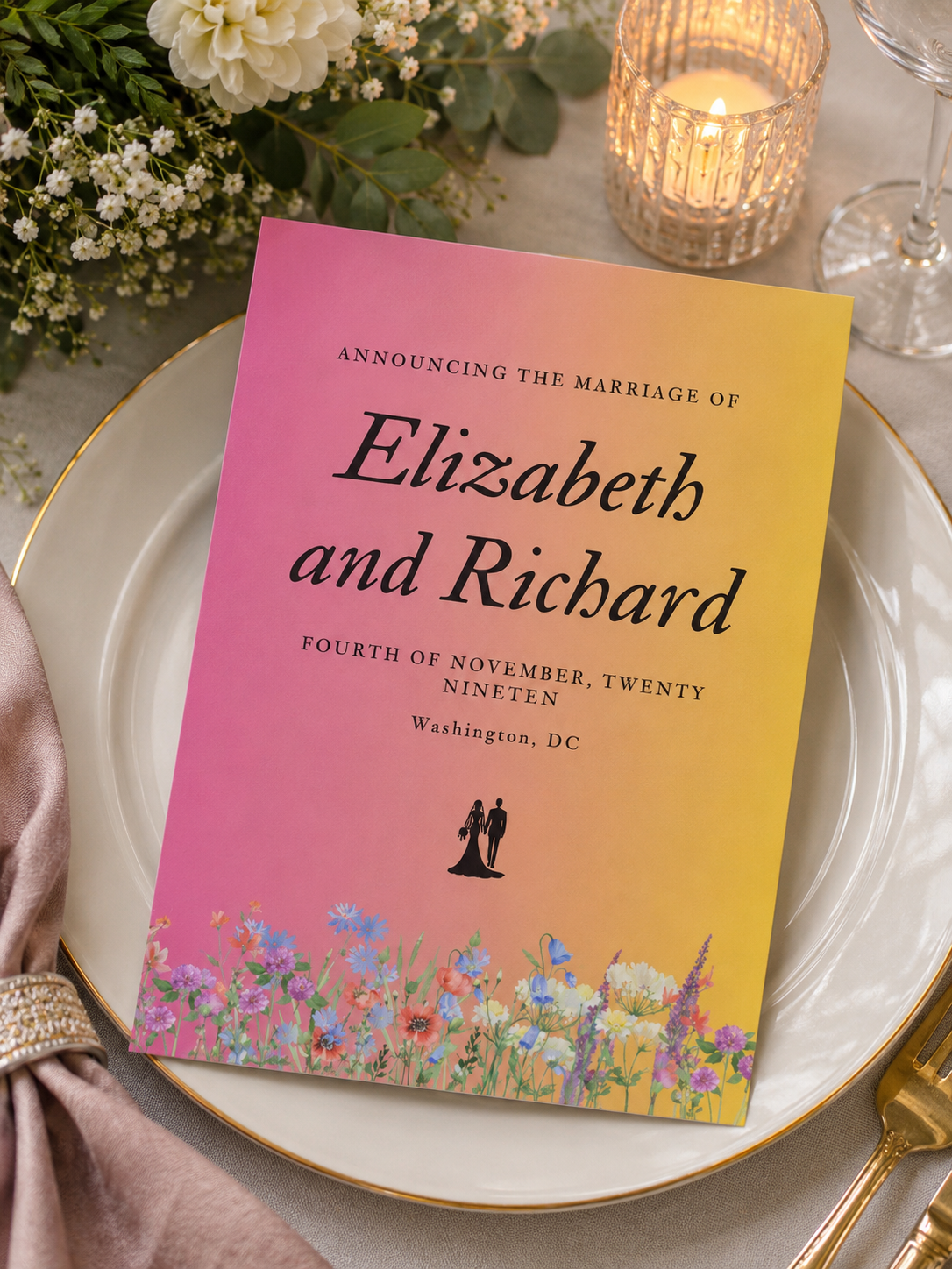 A wedding announcement card featuring a vibrant pink and yellow sunset ombre gradient background with meadow wildflowers.