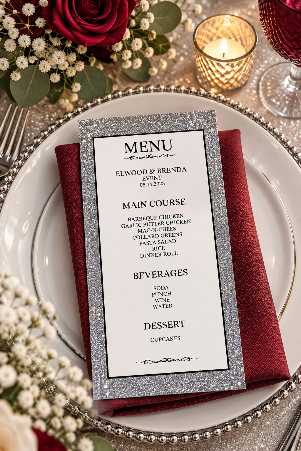 Two silver glitter printable event menus displayed on a decorative table with a red napkin, silver cutlery, and purple glass.